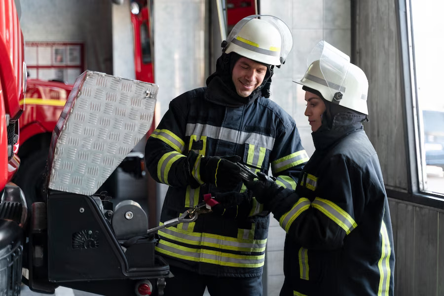 male-female-firefighters-working-together-suits-helmets_23-2149206362